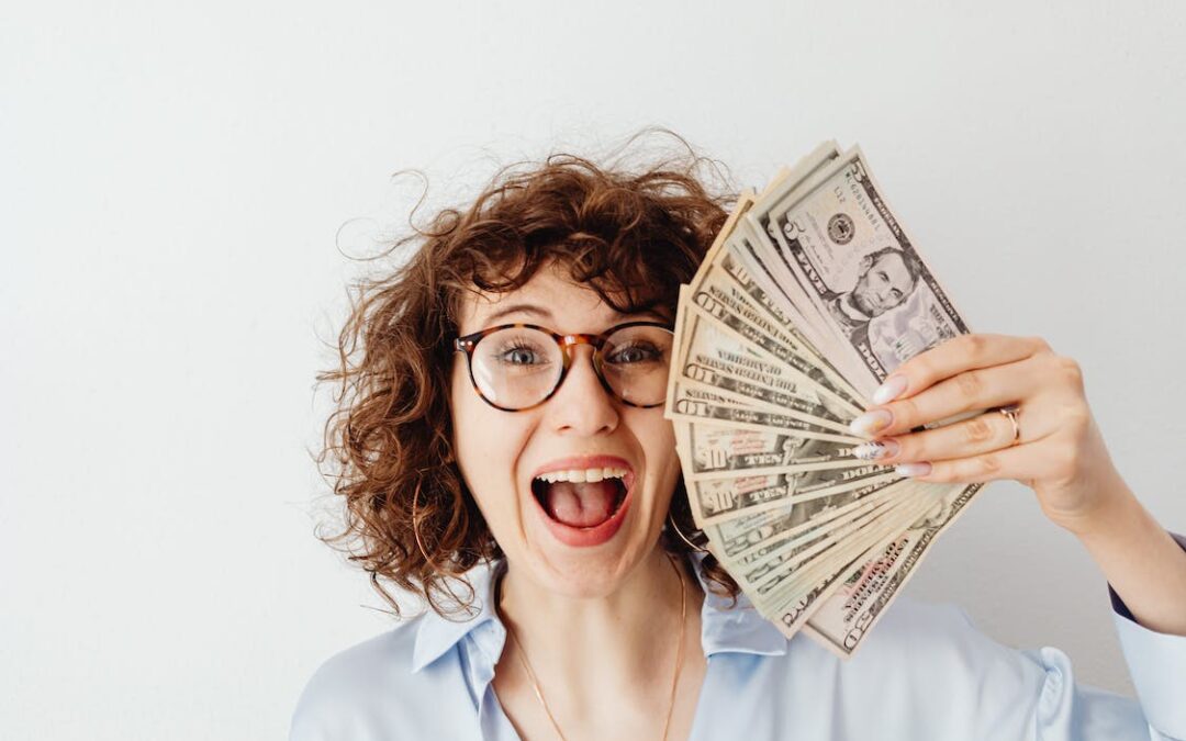 Happy woman holding dollar bills after learning how to offset relocation costs