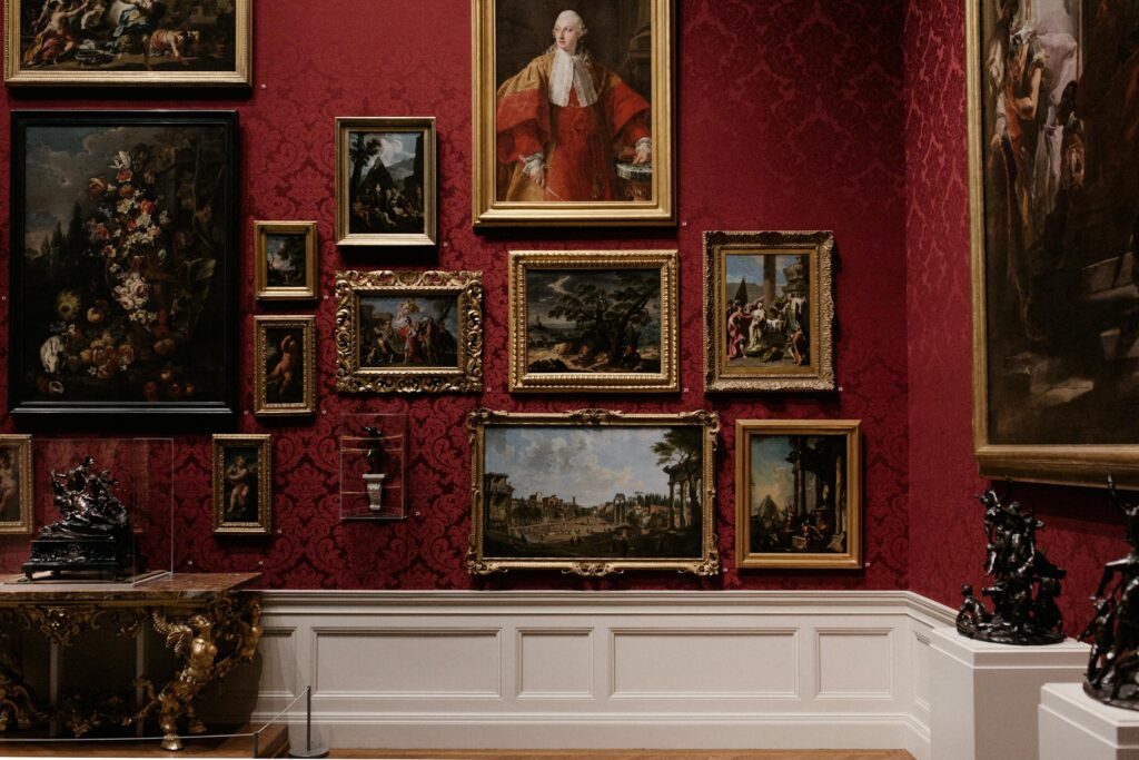 A red wall covered in famous paintings