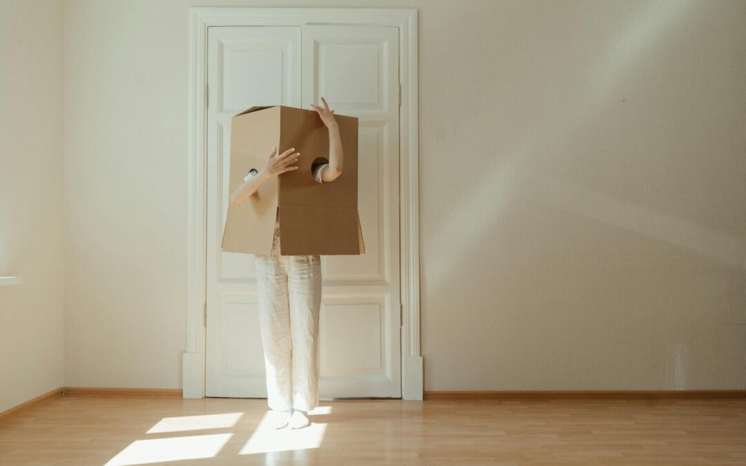 Woman in white pants on a wooden floor covered with a cardboard box